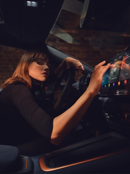 Woman using CUPRA dashboard infotainment screen